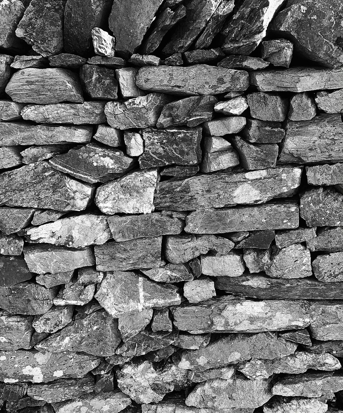 Close-up of a stacked stone wall.